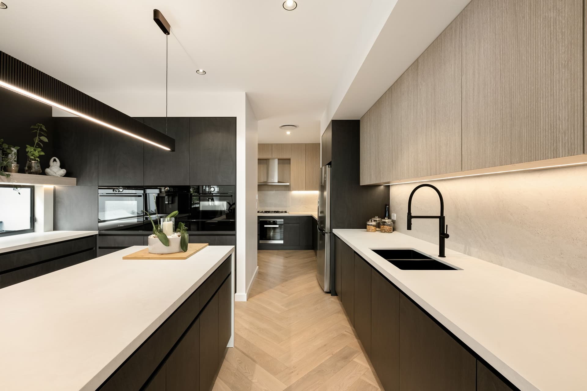 Kitchen with dark joinery and stone island