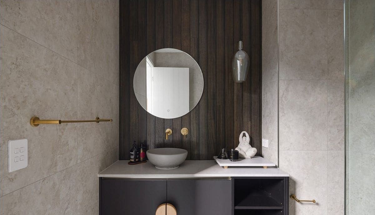 Powder room with a round mirror