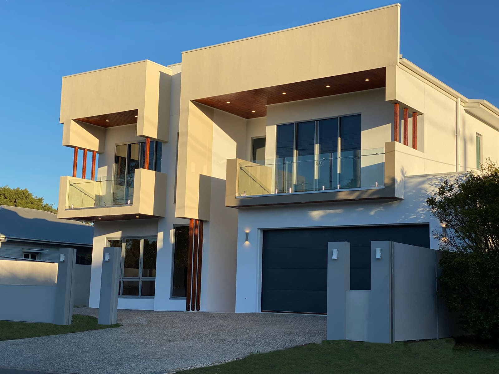 Rendered two-storey facade with glass balconies