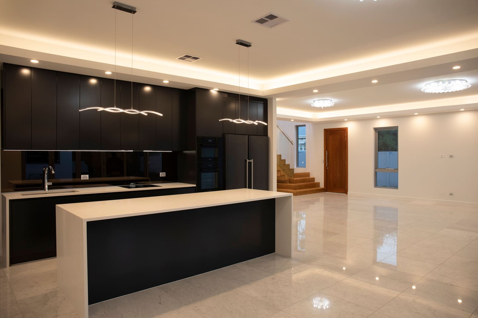 Kitchen with dark cabinetry and a stone island
