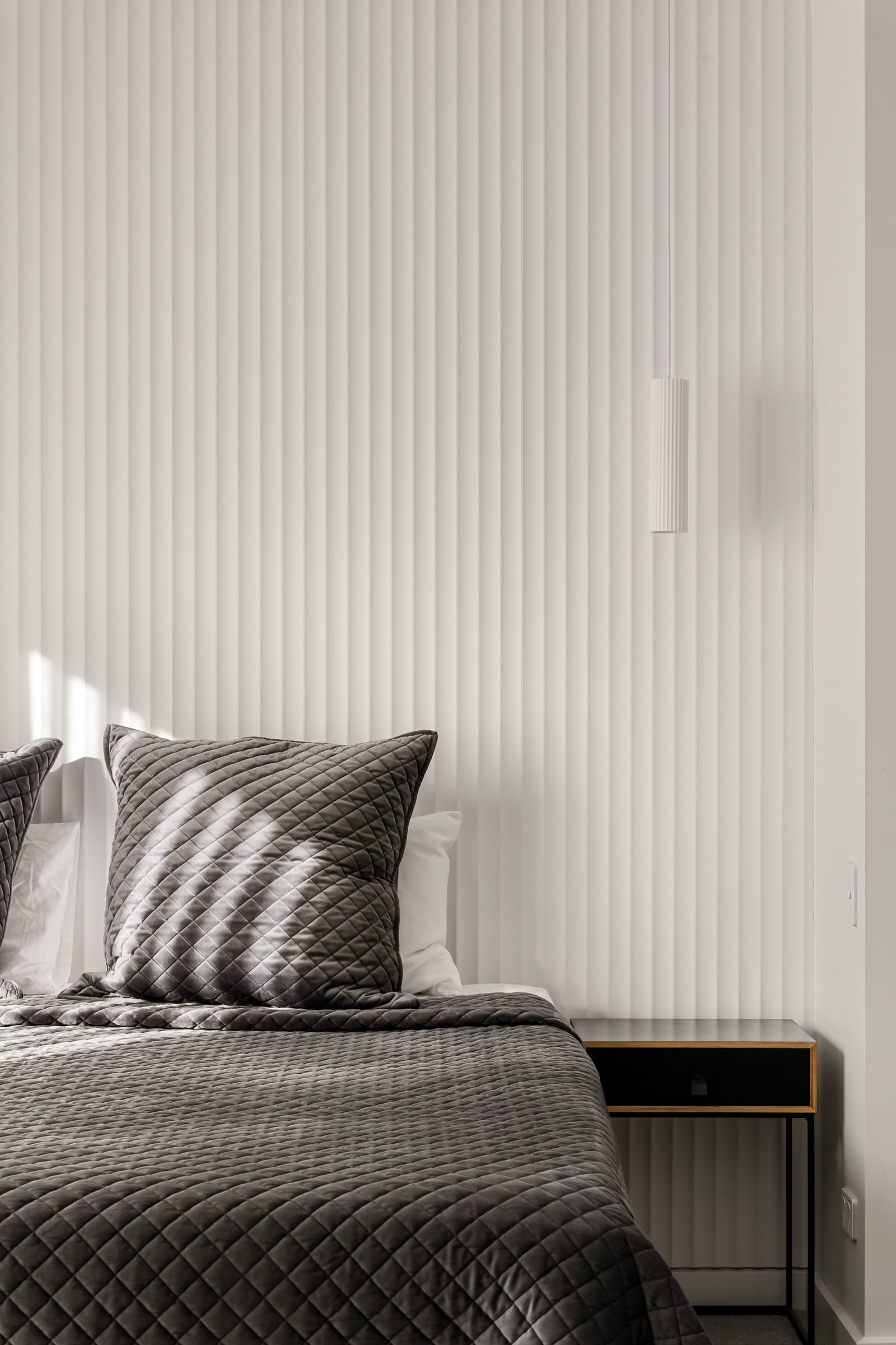 Fluted wall panelling behind the main bed in the St Lucia residence