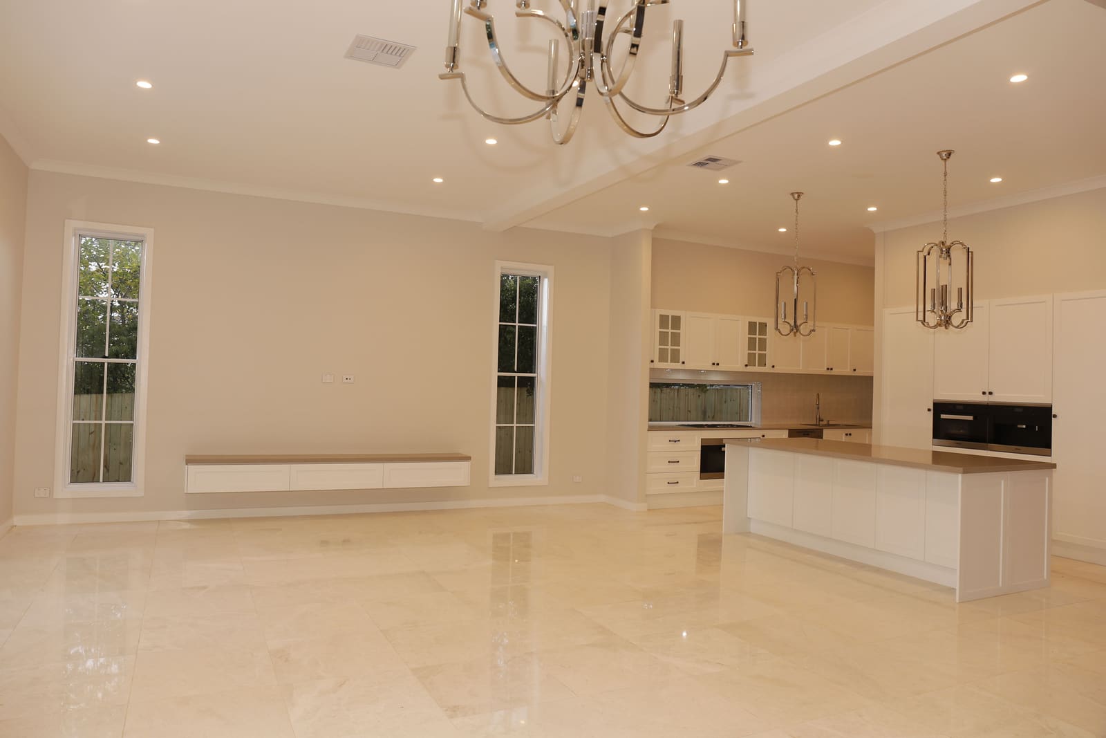 Open-plan kitchen and living with marble floors