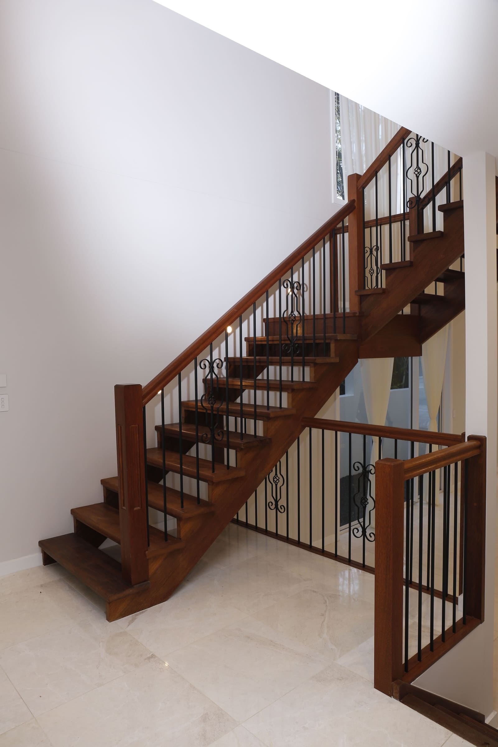 Timber stair with wrought-iron balusters