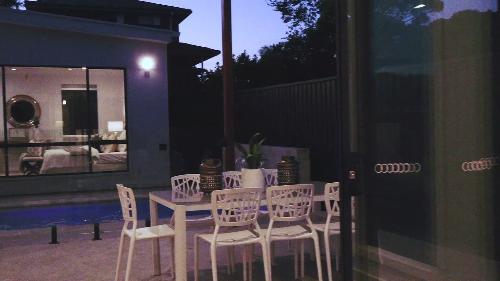 Alfresco dining and pool at dusk