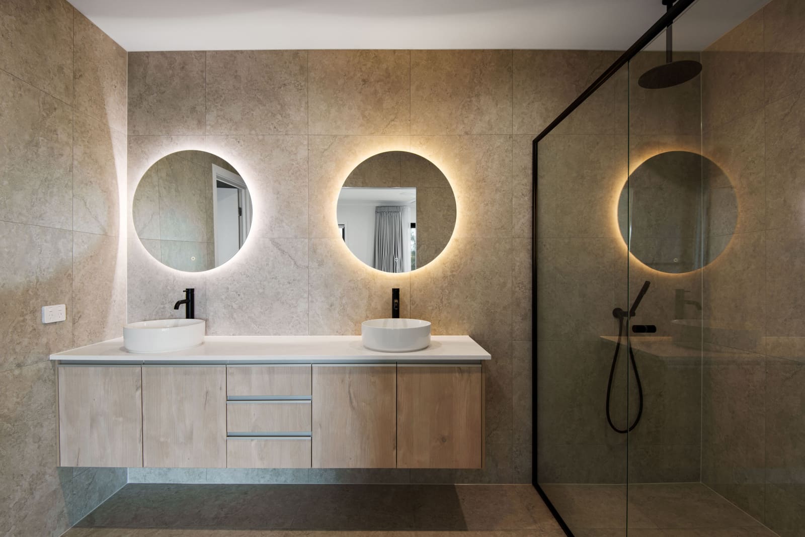 Ensuite with twin backlit round mirrors