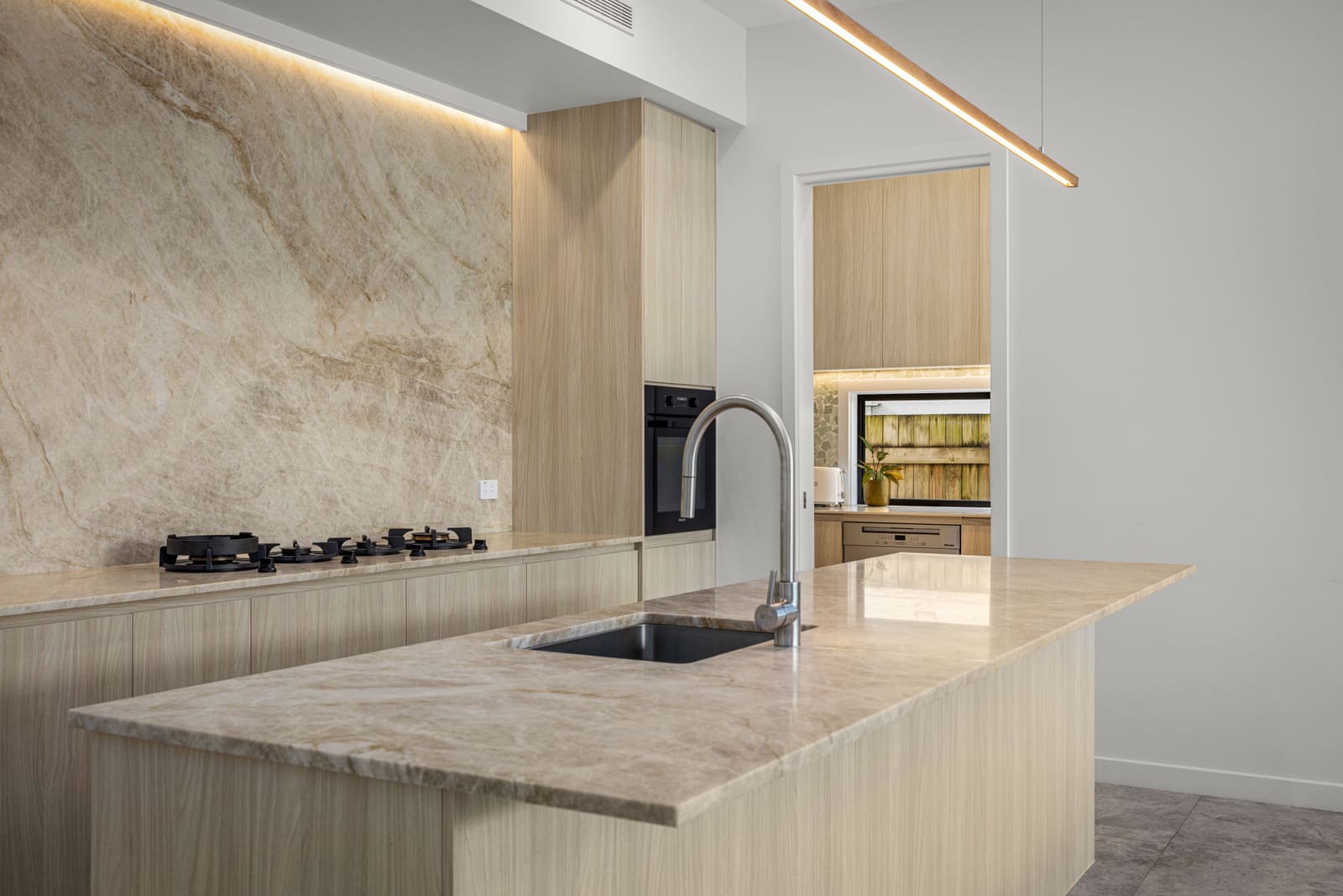 Stone island and cooktop in the kitchen