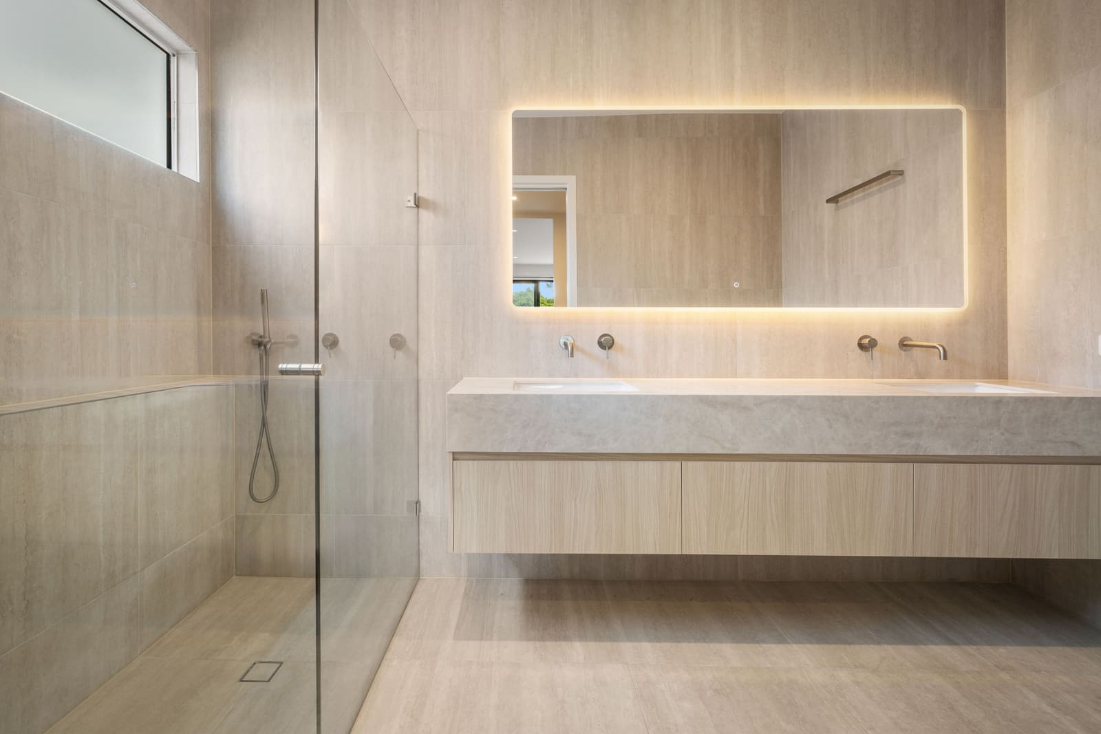 Ensuite with twin basins and a backlit mirror