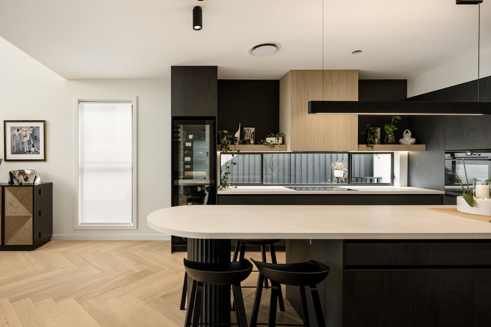 Stone kitchen island with timber bar stools