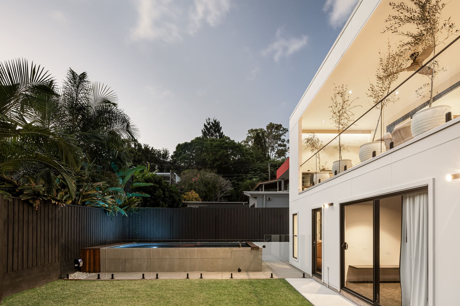 Rear terrace and pool at dusk