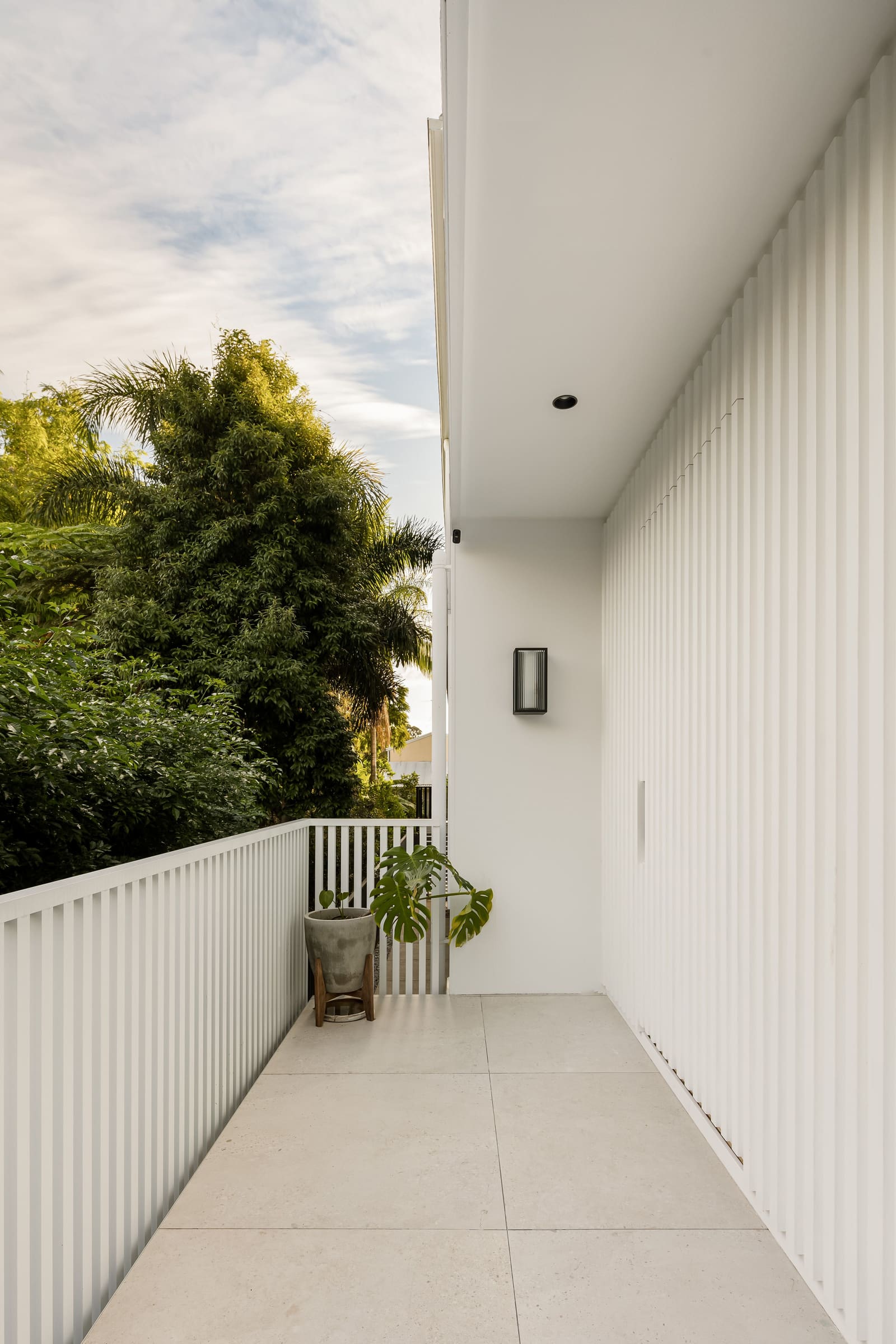White battened side elevation beside the garden