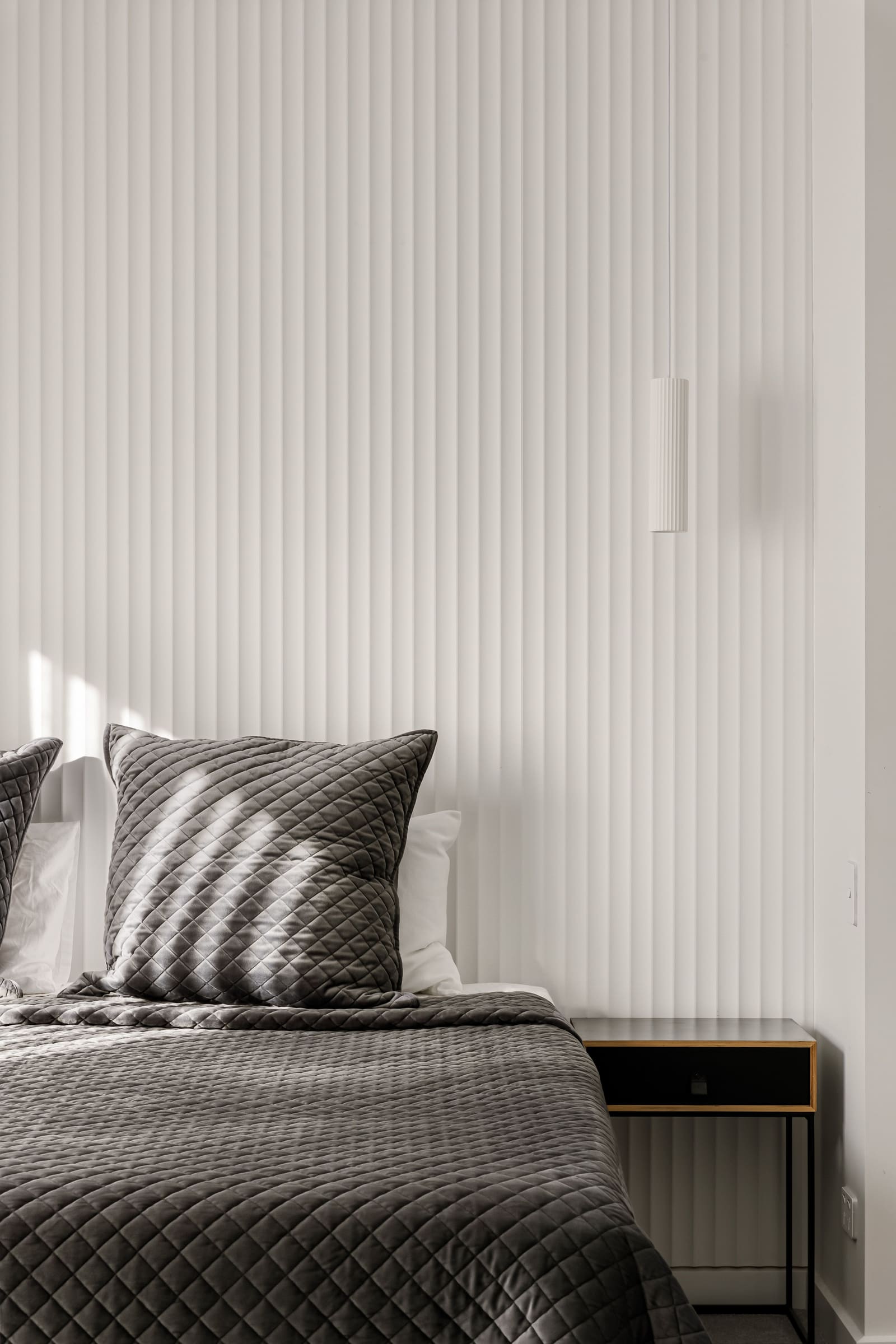 Fluted wall panelling behind the main bed