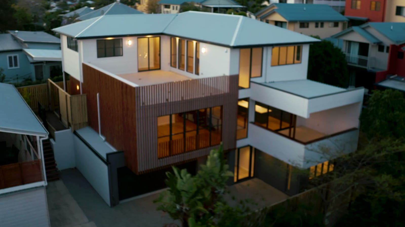 Three-storey home at dusk, seen from above