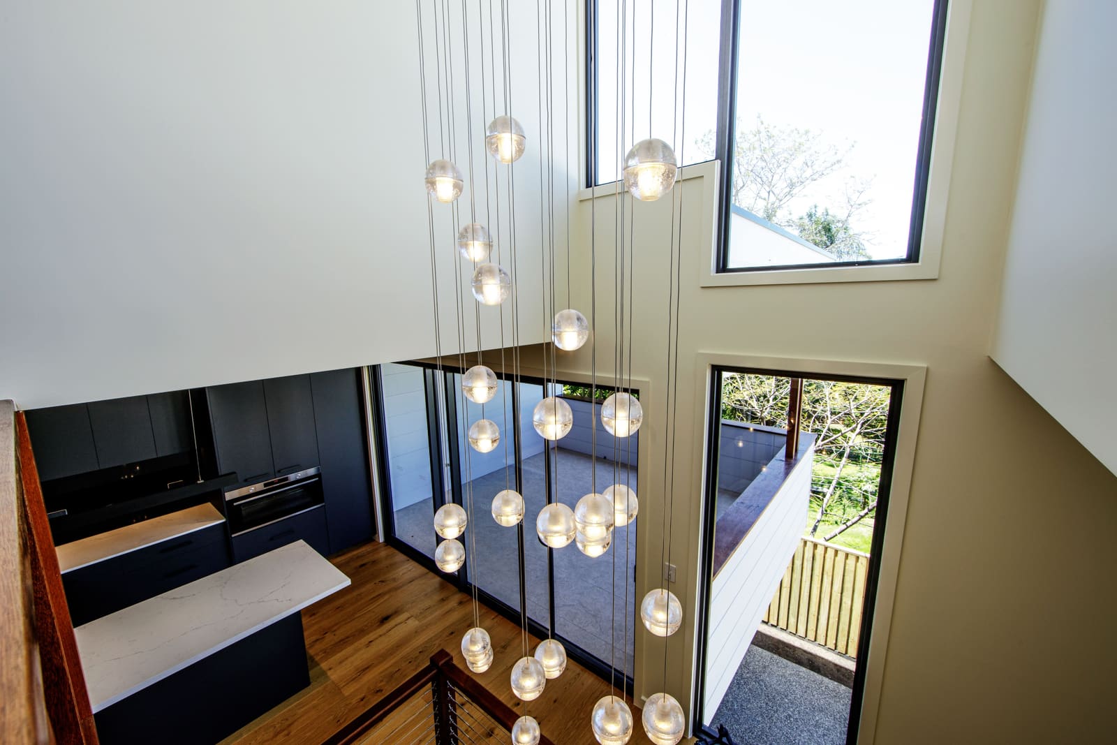 Pendant lights falling through the double-height void